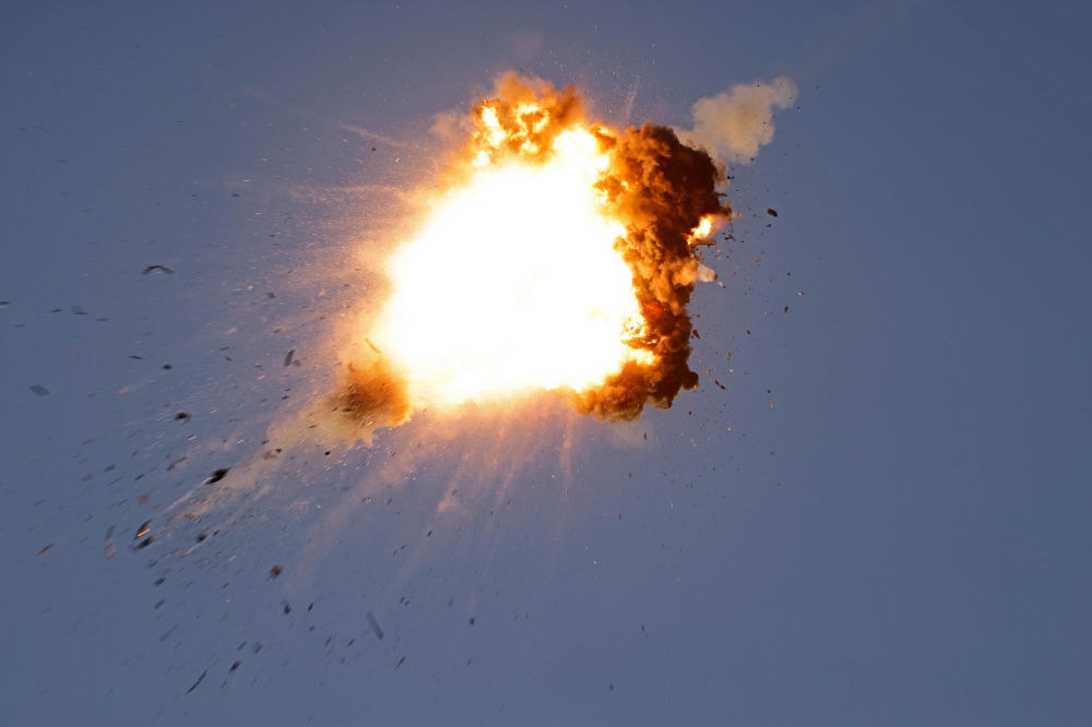 TOPSHOT - This photo taken from a position in northern Israel shows a Hezbollah UAV intercepted by Israeli air forces over north Israel on August 25, 2024. The Israeli military announced early August 25, 2024 that it was conducting pre-emptive strikes in Lebanon after detecting preparations for "large-scale" attacks by the Iran-backed militant group Hezbollah. Hezbollah said it had launched more than 320 rockets at Israel overnight, targeting a string of military positions, even as Israel's military said it was carrying out pre-emptive strikes against the group. (Photo by Jalaa MAREY / AFP)
