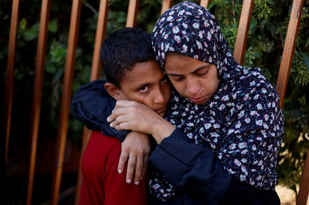Mourners react during the funeral of Palestinians killed in Israeli strikes in Khan Younis on Monday. - Reuters