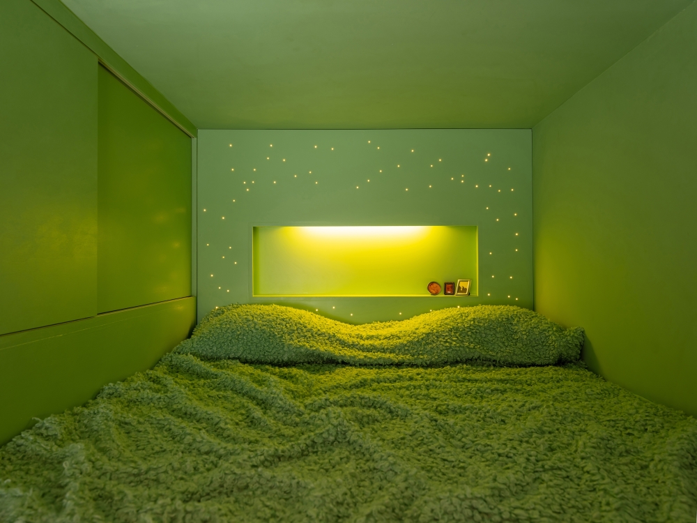 A 43-square-foot sleeping loft painted an invigorating shade of chartreuse in the tiny apartment designed by Beatriz Ramo L