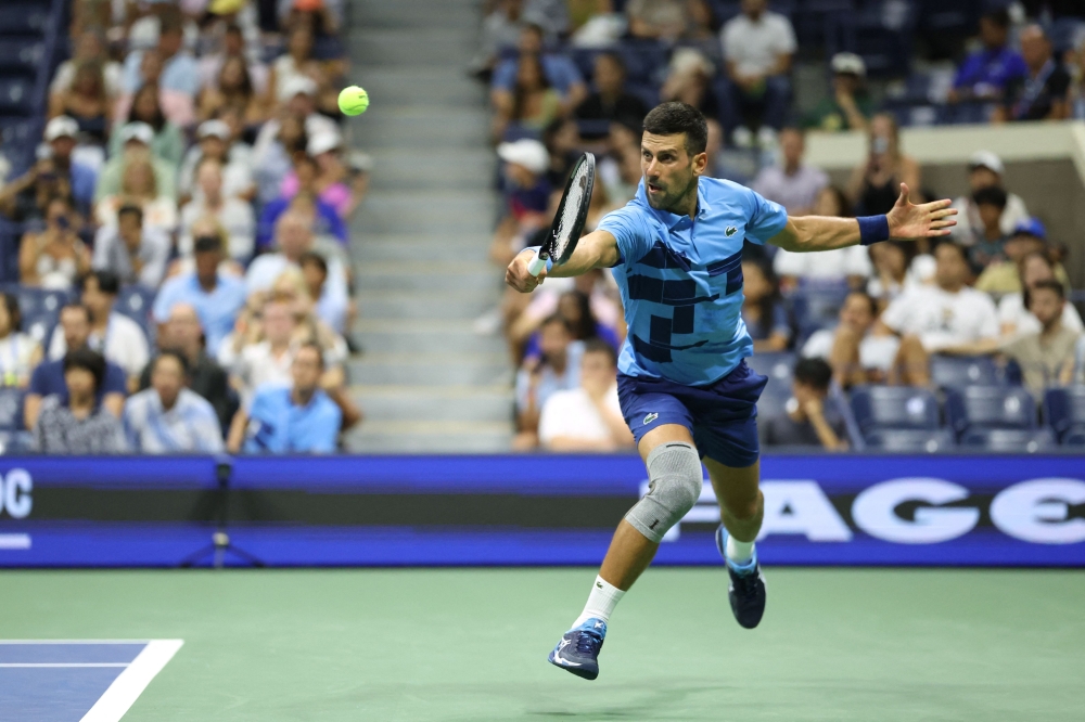 Serbia's Novak Djokovic returns the ball to Moldova's Radu Albot during their men's singles first round tennis match on day one of the US Open tennis tournament at the USTA Billie Jean King National Tennis Center in New York City, on August 26, 2024. (Photo by CHARLY TRIBALLEAU / AFP)

