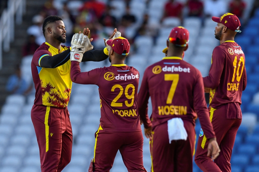 Romario Shepherd (L) of West Indies celebrates the dismissal of Aiden Markram (L) of South Africa during the 3rd and final T20i match between West Indies and South Africa at Brian Lara Cricket Academy in Tarouba, Trinidad and Tobago, on August 27, 2024. (Photo by Randy Brooks / AFP)