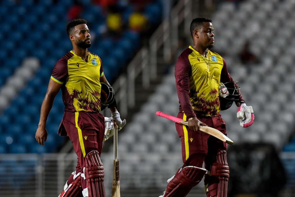 Shai Hope (L) and Shimron Hetmyer (R) of West Indies walking off the field after winning the 3rd and final T20i match between West Indies and South Africa at Brian Lara Cricket Academy in Tarouba, Trinidad and Tobago on August 27, 2024. (Photo by Randy Brooks / AFP)

