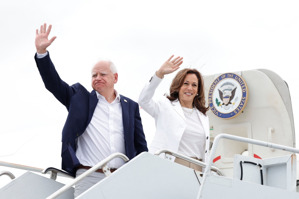 US Vice President and 2024 Democratic presidential candidate Kamala Harris and her running mate Minnesota Governor Tim Walz board Air Force Two, departing Chippewa Valley Regional Airport in Eau Claire, Wisconsinon. - AFP