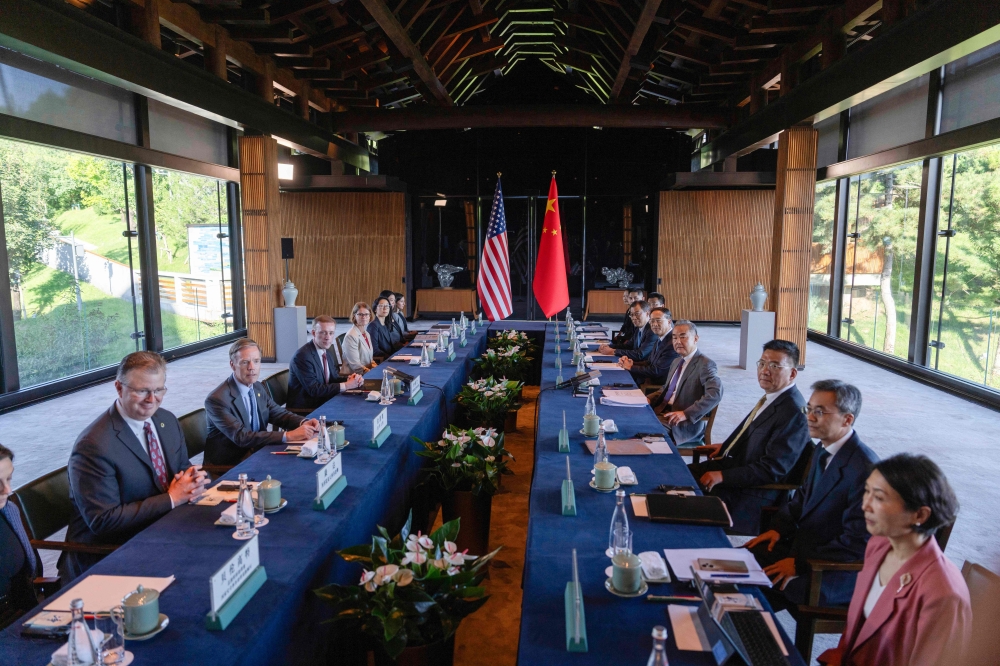 China's Foreign Minister Wang Yi and US National Security Advisor Jake Sullivan (3rd L) before talks at Yanqi Lake in Beijing. - AFP


