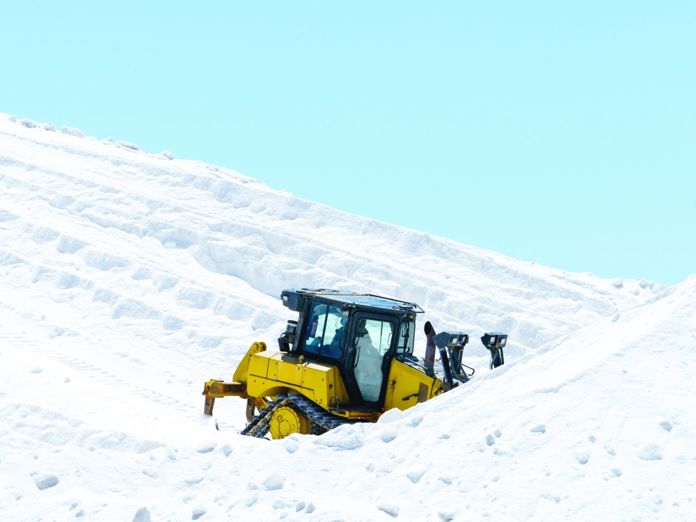 A worker harvests salt from Mediterranean seawater left to evaporate in giant pans, near the town of Aigues-Mortes, in the Camargue region of France, July 7, 2024. (Alex Cretey-Systermans/The New York Times)