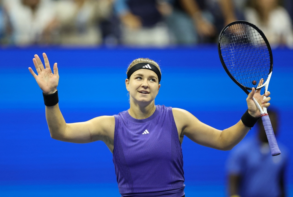 Czech Republic's Karolina Muchova celebrates after defeating Japan's Naomi Osaka during their women's singles second round tennis match