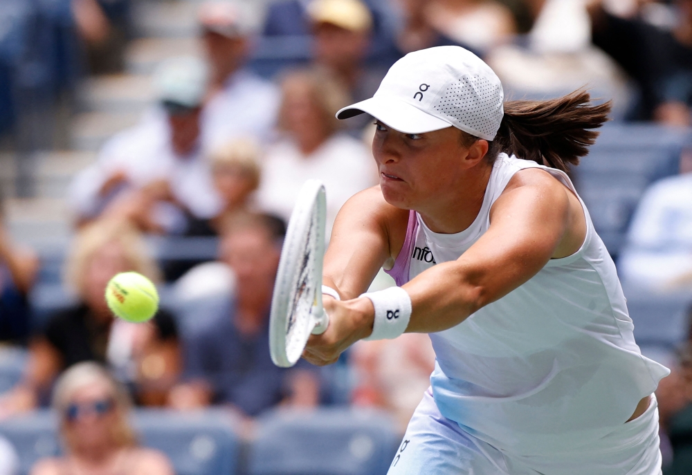 Poland's Iga Swiatek hits a return to Japan's Ena Shibahara during their women's singles second round tennis match 