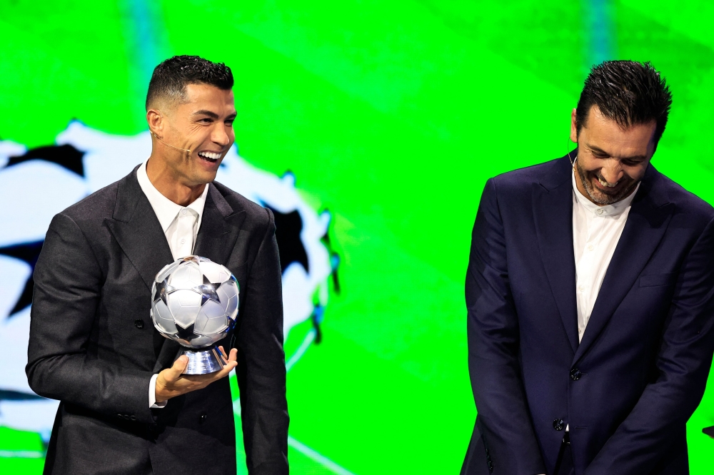Portugal's national team player and Saudi Al-Nassr's forward Cristiano Ronaldo who is awarded the All-Time Goalscorer Award in the UEFA Champions League (L) and Italy's former goalkeeper 