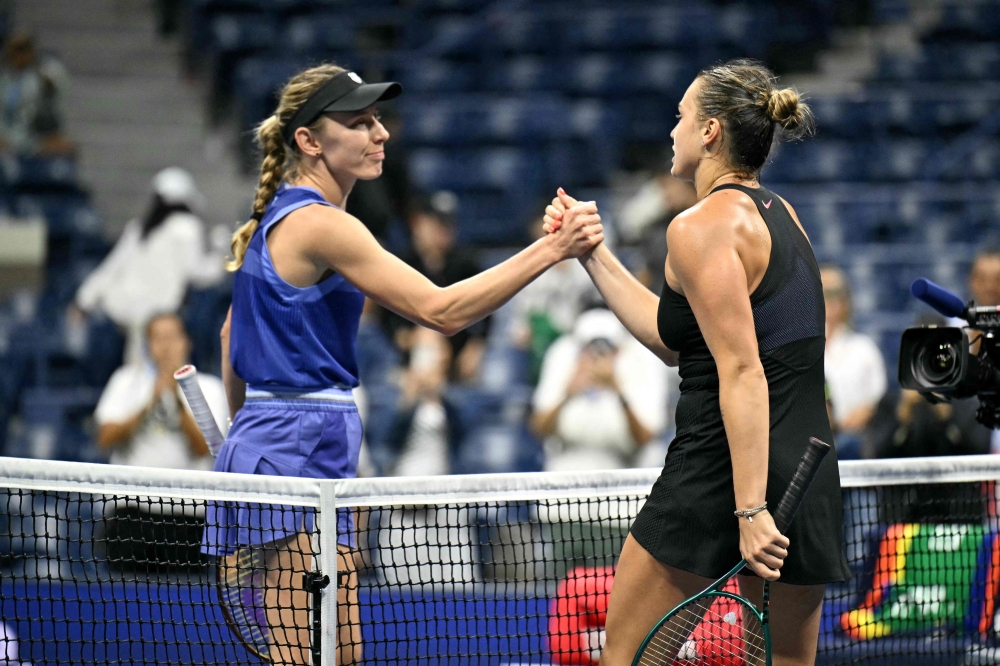 Belarus's Aryna Sabalenka (R) greets  Russia's Ekaterina Alexandrova  after her victory in their women's singles third round match on day five of the US Open tennis tournament at the USTA Billie Jean King National Tennis Center in New York City, on August 30, 2024. (Photo by ANGELA WEISS / AFP)

