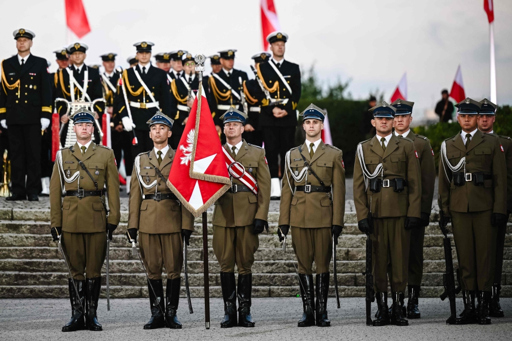Polish honour guard soldiers stand guard during a ceremony marking the 85th anniversary of the start of World War II on the Westerplatte peninsula in Gdansk. — AFP 