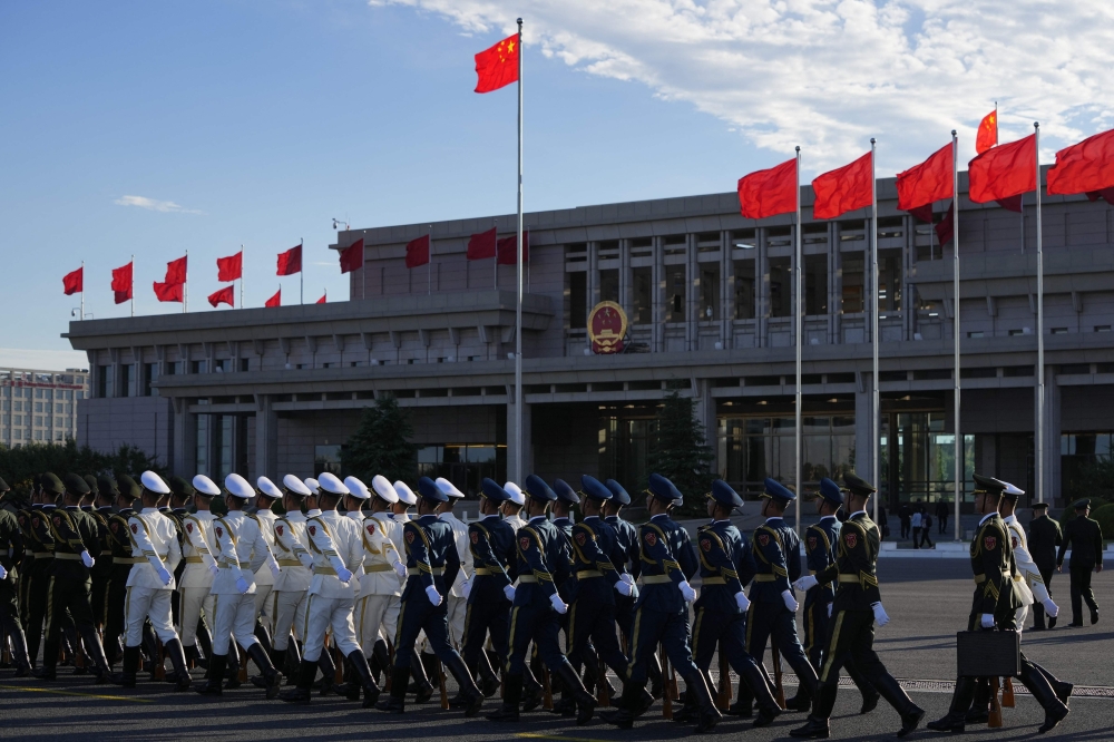 Chinese honour guards walk past the vip terminal after the arrival of Togo's President Faure Gnassingbe at Beijing Capital International Airport. — AFP 