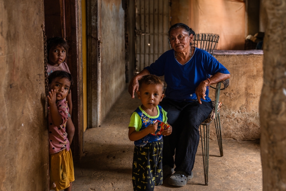 Xiomara Ortega, with her grandchildren at her home in Maracaibo, Venezuela on July 23, 2024. Ortega takes care of six grandchildren after her daughters migrated to Colombia. (Marian Carrasquero/The New York Times)