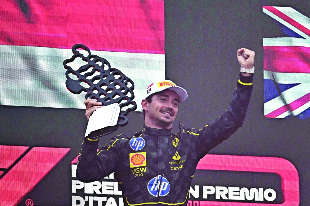 Winner Ferrari's Monegasque driver Charles Leclerc celebrates on the podium after the Italian Formula One Grand Prix race at Autodromo Nazionale Monza circuit, in Monza on September 1, 2024. (Photo by Gabriel BOUYS / AFP)

