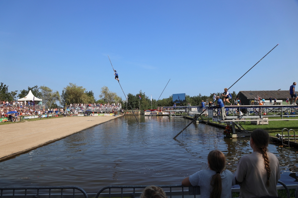A contestant takes part in a yearly national 'fierljeppen' or canal vaulting contest in the village of Polsbroekerdam, Netherlands August 31, 2024. REUTERS/Bart Biesemans
