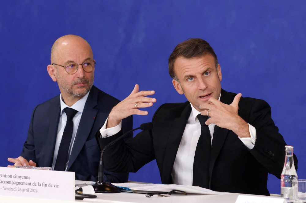 France's President Emmanuel Macron, next to CESE's president Thierry Beaudet (L), delivers a speech, in Paris. — AFP file photo