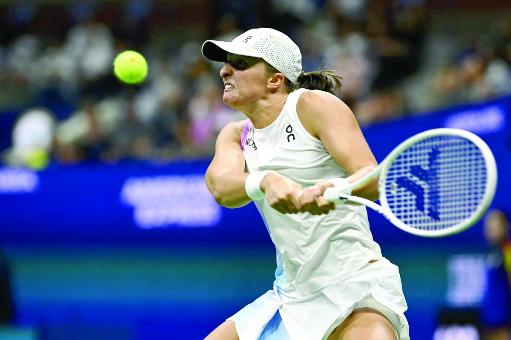 Poland's Iga Swiatek hits a return to Russia's Liudmila Samsonova during their women's singles round of 16 match on day eight of the US Open tennis tournament at the USTA Billie Jean King National Tennis Center in New York City, on September 2, 2024. 