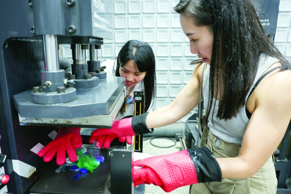 Debbie Wu operates miniTrashpresso, which turns plastic waste into materials to make sunglasses, at Trash Kitchen in Taipei, Taiwan.