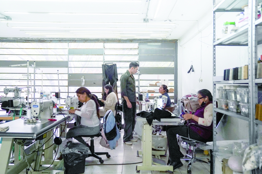 Mexican designer Patricio Campillo, who will debut at New York Fashion Week, speaks to a seamstress in his studio in Mexico City, Mexico.