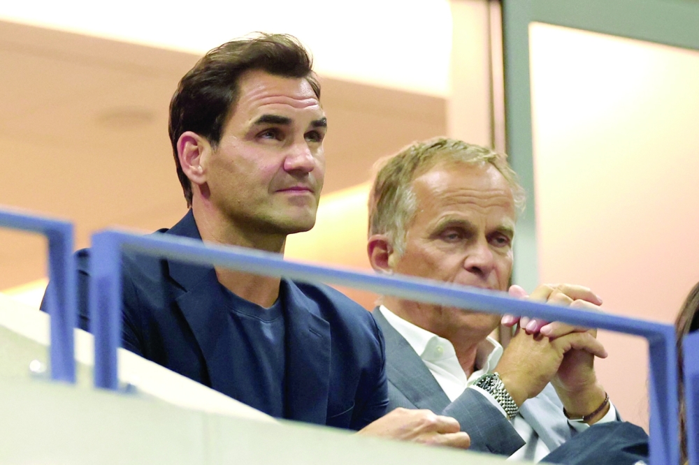 Swiss former professional tennis player Roger Federer (L) attends the women's quarterfinals match between Belarus's Aryna Sabalenka and China's Zheng Qinwen on day nine of the US Open tennis tournament at the USTA Billie Jean King National Tennis Center in New York City.