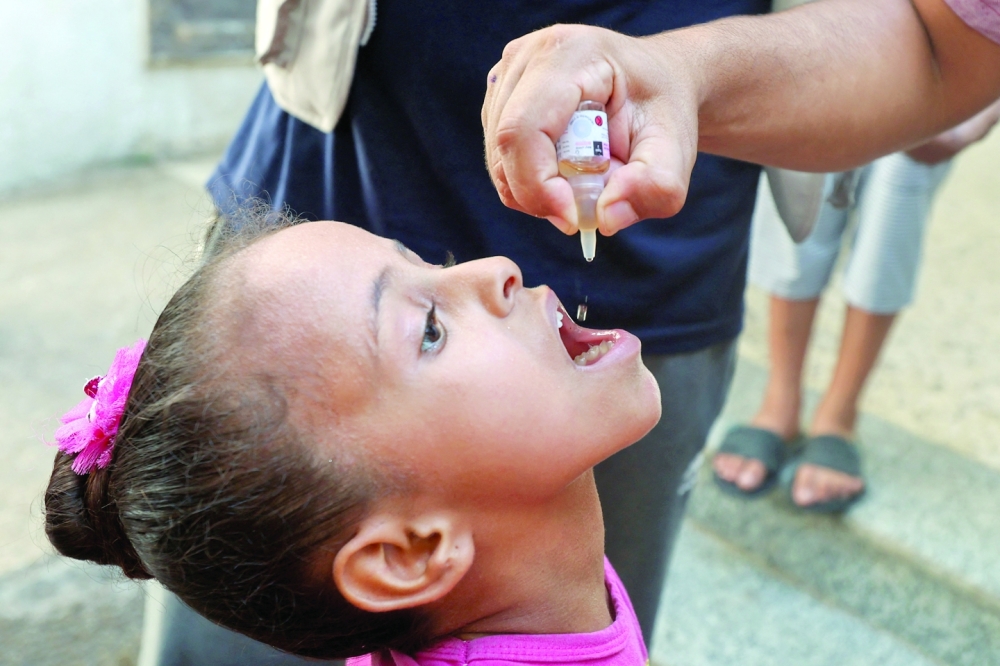 A Palestinian child is vaccinated against polio in Deir Al Balah in the central Gaza Strip. — Reuters