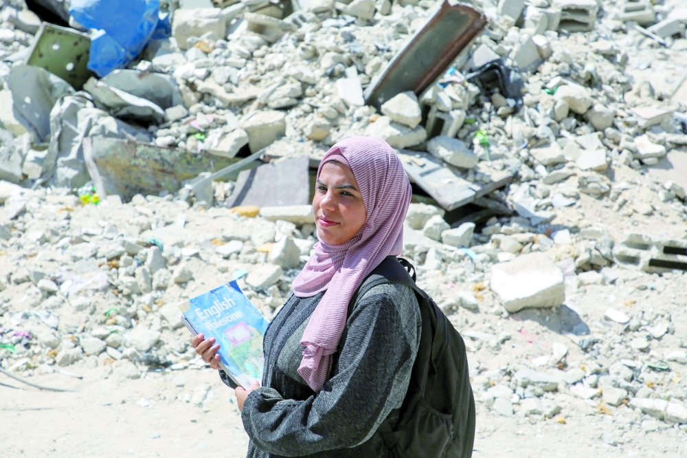 Palestinian teacher Israa Abu Mustafa, who set up a classroom tent on the rubble of her house to educate children, poses for a photo, in Khan Yunis, in the southern Gaza Strip, on Wednesday. — Reuters
