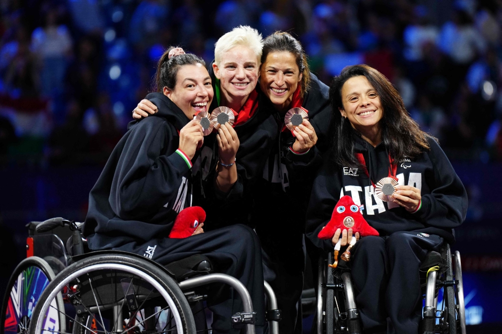 (From L) Bronze medallists Italy's team members Andreea Mogos, Bebe Vio, Loredana Trigilia and Rossana Pasquino pose on the podium during the victory ceremony for the Women's wheelchair 