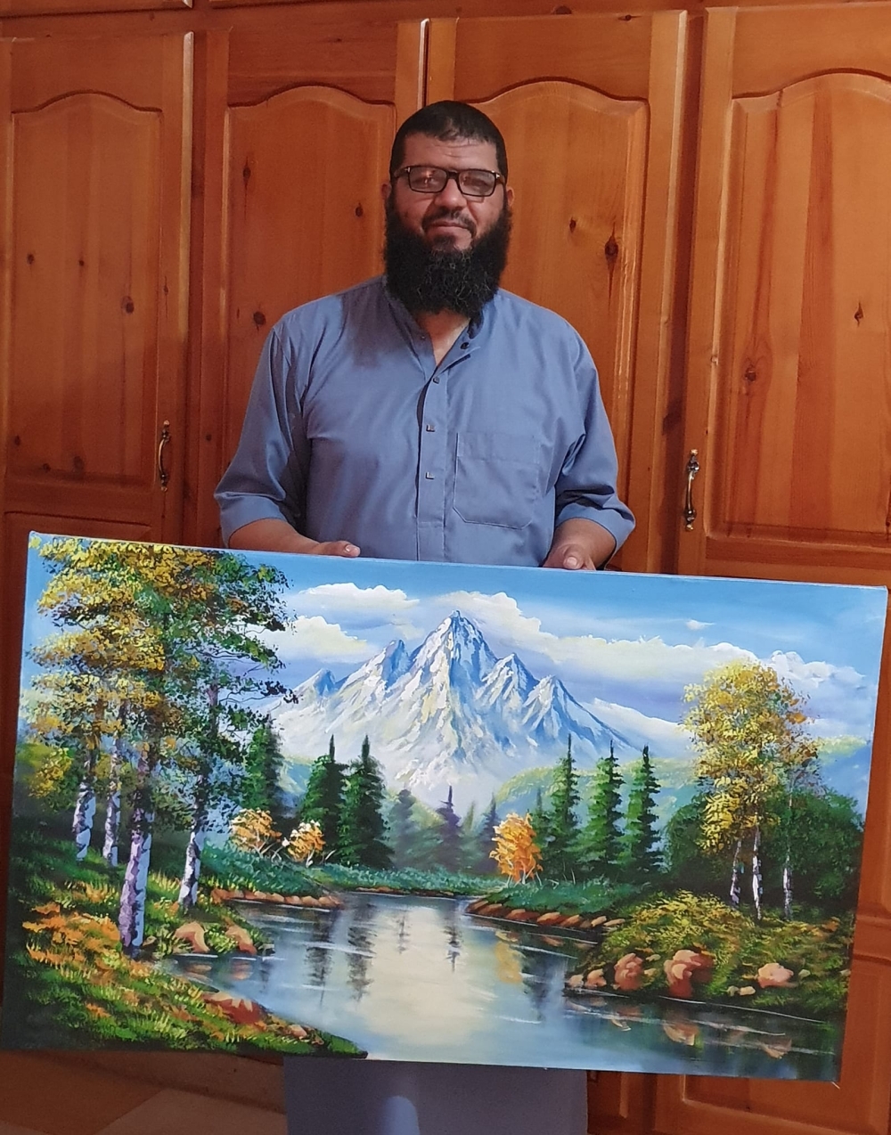 Dr Houari Hammou with his creative works of art