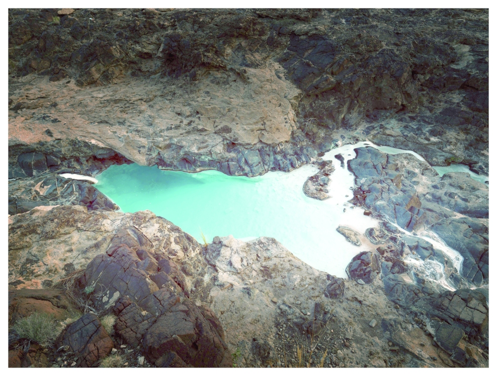 Solid white carbonate, settled at the bottom of a pool, in Oman.