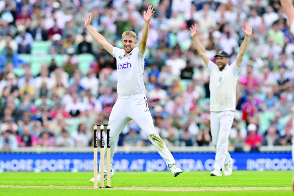 England's Olly Stone (L) celebrates after dismissing Sri Lanka's Dinesh. — AFP

