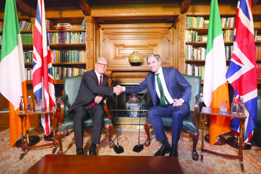 Ireland's Prime Minister Simon Harris and Britain's Prime Minister Keir Starmer shakes hands inside Farmleigh House in Dublin. — AFP