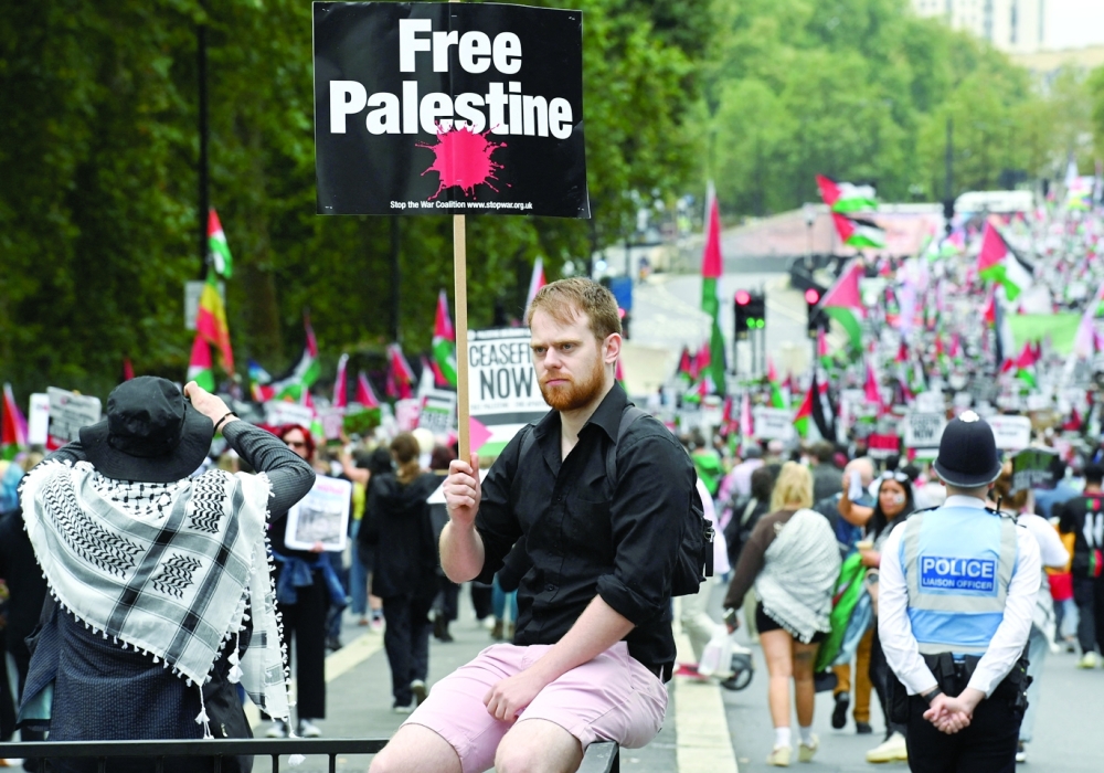 A man holds a sign during a demonstration in support of Palestinians in Gaza, in London, Britain. — Reuters