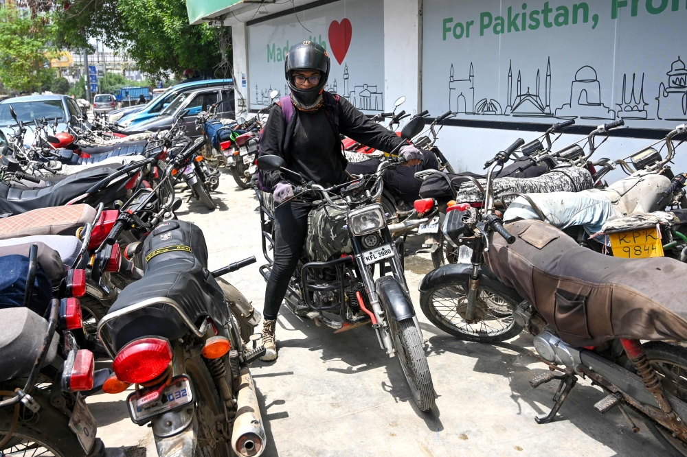 Amina Sohail, a motorbike rider with a local ride-hailing service provider Bykea