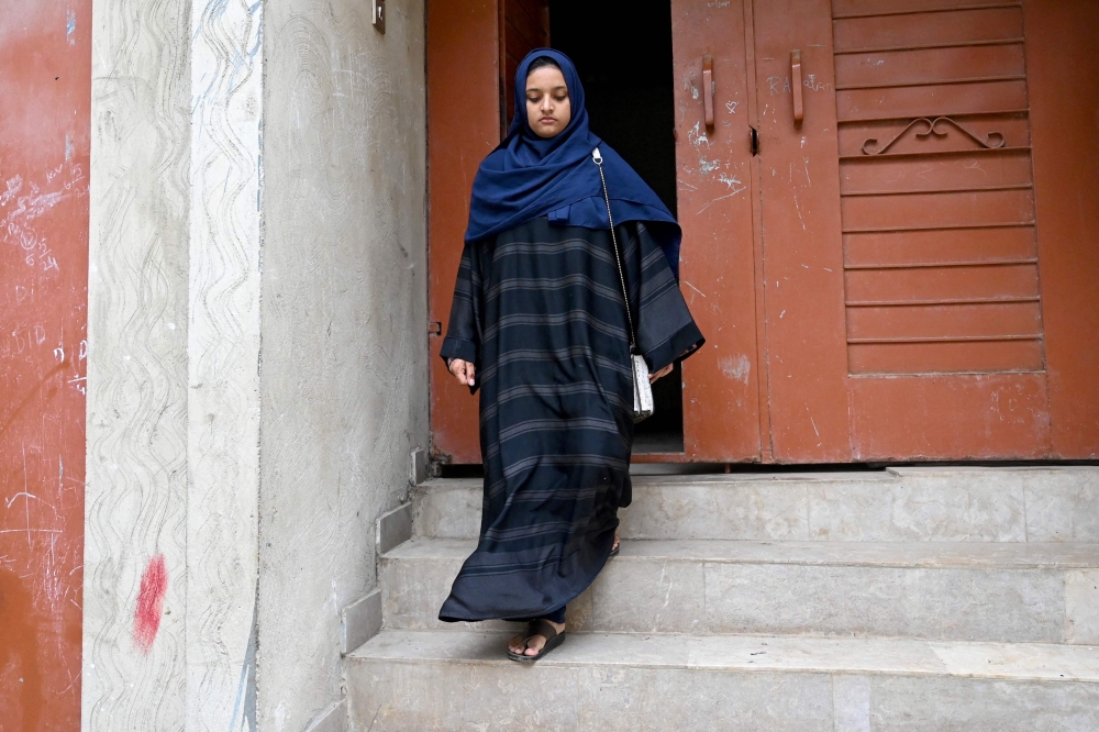 Childminder Zahra Afzal heads to work, in Karachi