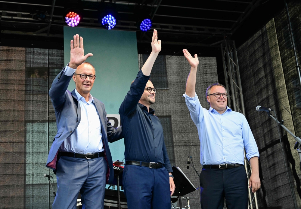 The leader of Germany's Christian Democratic Union party Friedrich Merz, CDU party's top candidate for Brandenburg's regional state elections Jan Redmann and the CDU's top candidate for regional elections in Thuringia Mario Voigt (R), during a campaign event ahead of Brandenburg's regional state elections in Brandenburg an der Havel, eastern Germany. -  AFP

