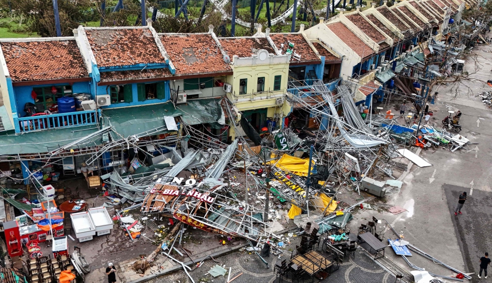 Damaged buildings and debris on a street after Super Typhoon Yagi hit Ha Long, in Quang Ninh province. — AFP 