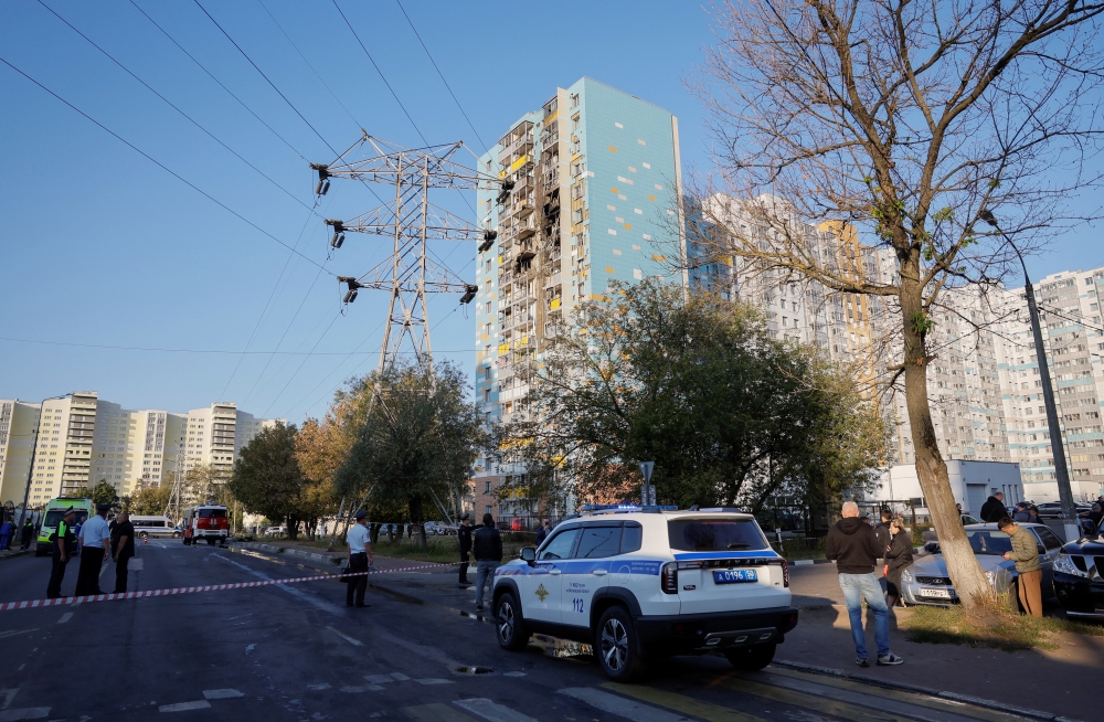 Police officers use tape to block off the area near a damaged multi-storey residential building, in Ramenskoye in Moscow. — Reuters 