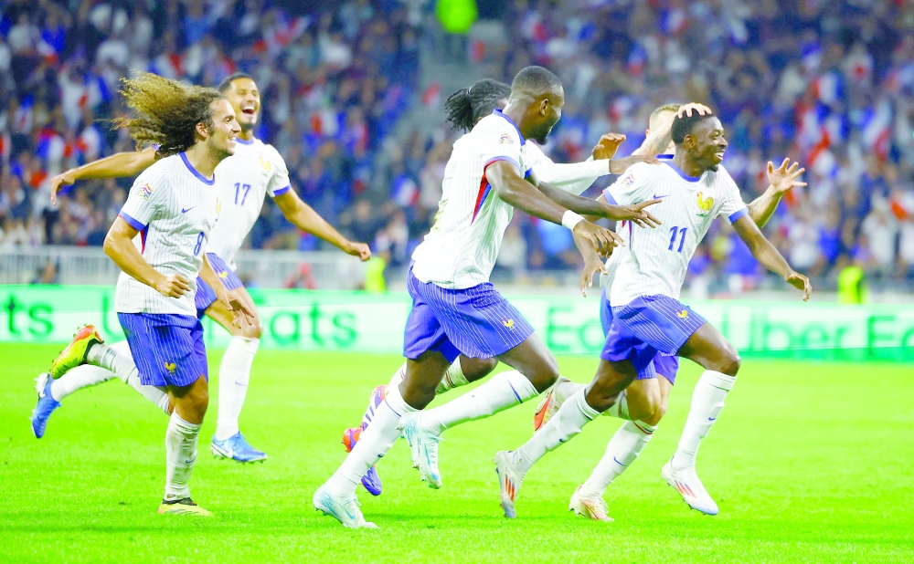 Soccer Football - Nations League - League A - Group 2 - France v Belgium - Groupama Stadium, Lyon, France - September 9, 2024 France's Ousmane Dembele celebrates scoring their second goal with teammates REUTERS/Sarah Meyssonnier
