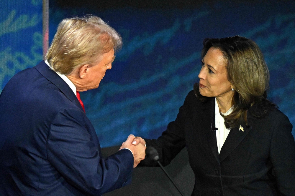 Kamala Harris shakes hands with Donald Trump