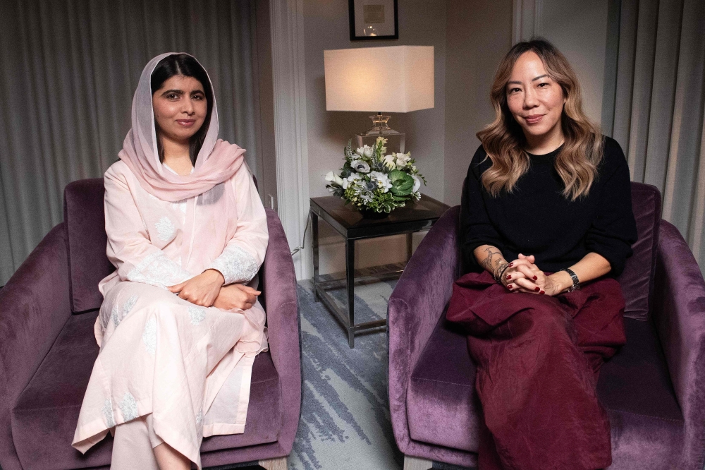 Pakistani producer Malala Yousafzai (L) and US-Korean director Sue Kim pose for AFP during a photo session at the Toronto International Film Festival (TIFF) in Toronto, Ontario, Canada, on September 9, 2024. The documentary "The Last of the Sea Women" produced by Yousafzai and directed by Kim premiered last night at the festival. (Photo by VALERIE MACON / AFP)

