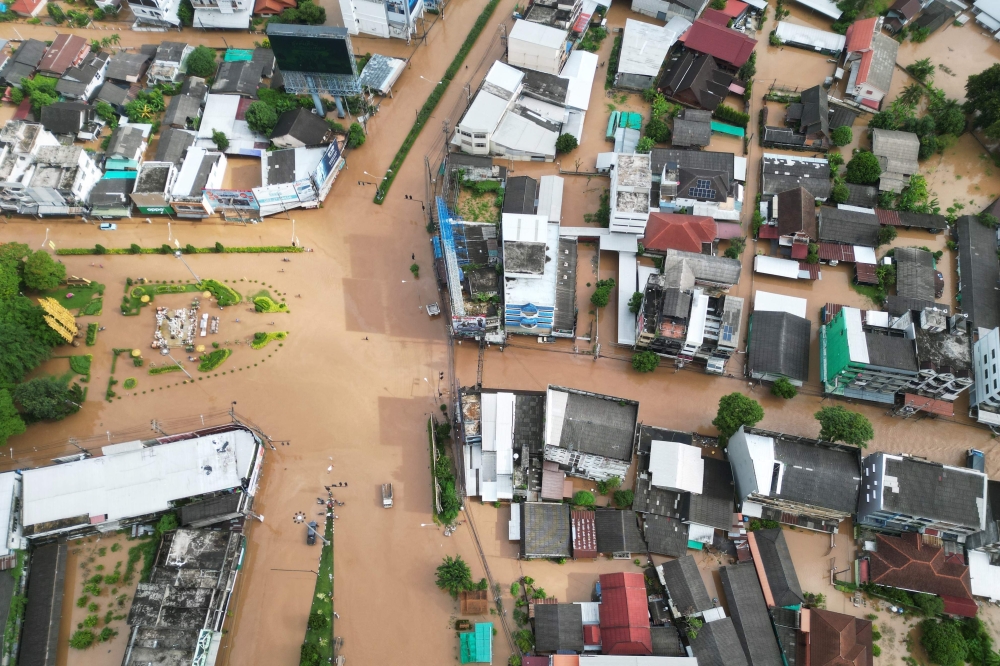 Aerial photo shows flood waters surrounding houses in the northern Thai city of Chiang Rai. - AFP