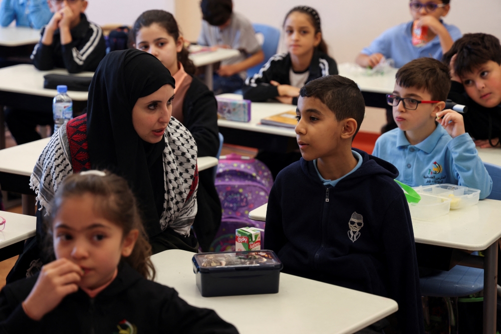 Mahmoud Ajjour, an injured child evacuated from Gaza at the Palestinian School in Doha. - Reuters
