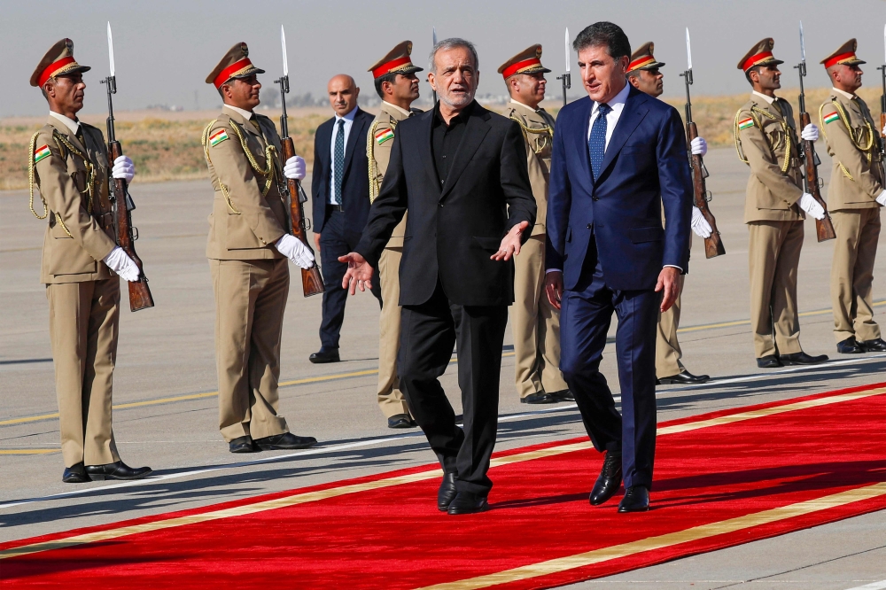 Nechirvan Barzani, the regional president of Iraqi Kurdistan, welcomes Iranian President Masoud Pezeshkian in Iraq's Kurdish regional capital Arbil upon his arrival from Baghdad. - AFP

