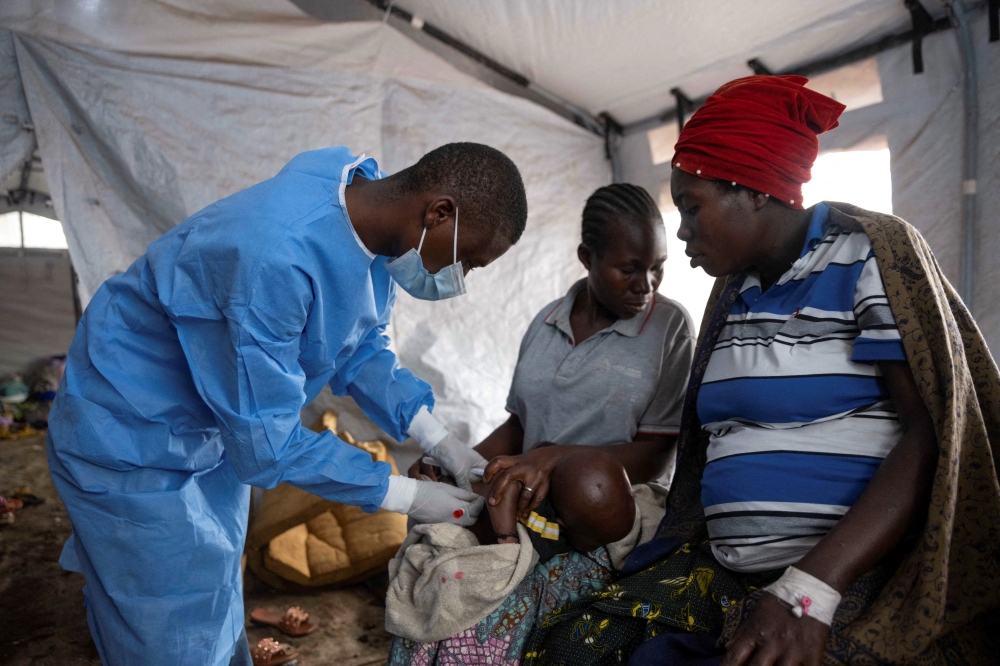 A Congolese nurse takes a sample from a suspected mpox patient in the treatment centre at the Kavumu hospital, the Democratic Republic of Congo 