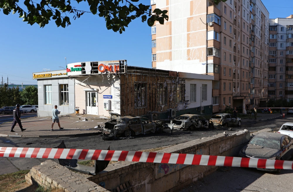 Burnt-out cars are seen near a residential building after shelling, in Belgorod, Russia. — Reuters 