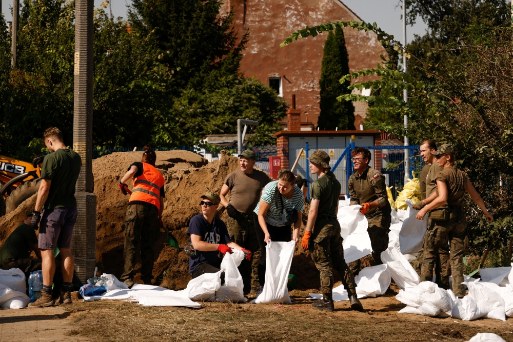 Soldiers and civilian volunteers fill sandbags in Wroclaw, Poland. — Reuters 