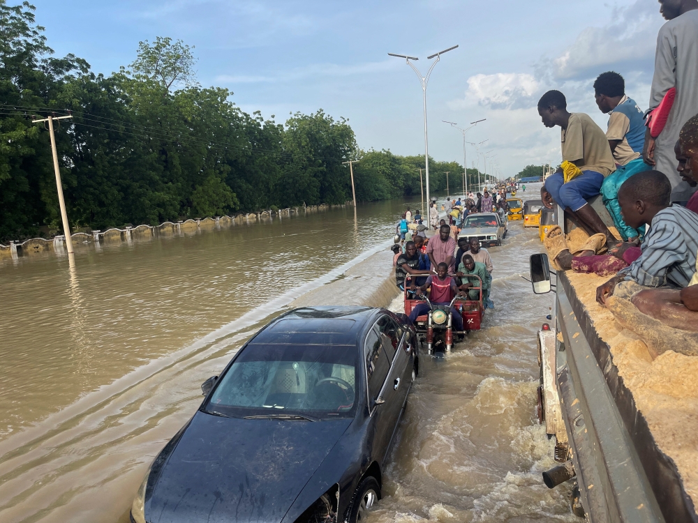Residents leave the flooded areas with their belongings in Maiduguri, Nigeria. — Reuters file photo