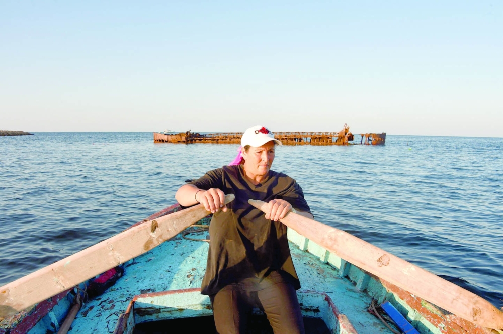 Tunisian fisherwoman Sara Souissi rows her boat along the coast of Tunisia's Kerkennah Islands in the Mediterranean Sea in the south of the country, on August 8, 2024. Souissi began fishing as a teenager in a family of fishers off their native Kerkennah Islands near the city of Sfax, defying men who believed she had no place at sea. A substantial portion of Tunisia is coastal or near the coast, making the sea an essential component of everyday life.