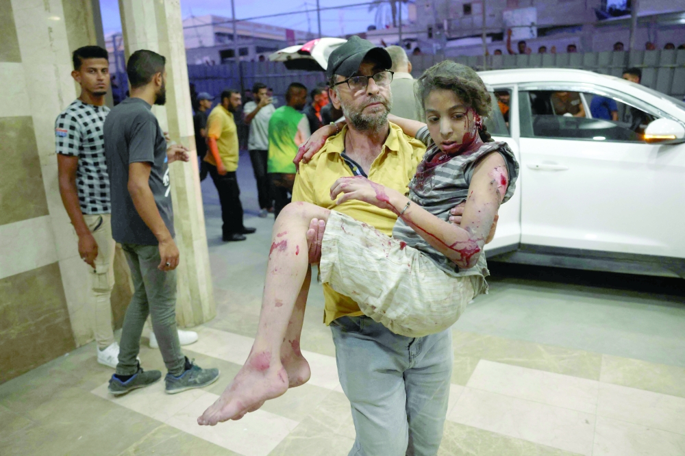 An injured girl is brought to the Naser hospital for treatment following an Israeli strike near Khan Yunis 