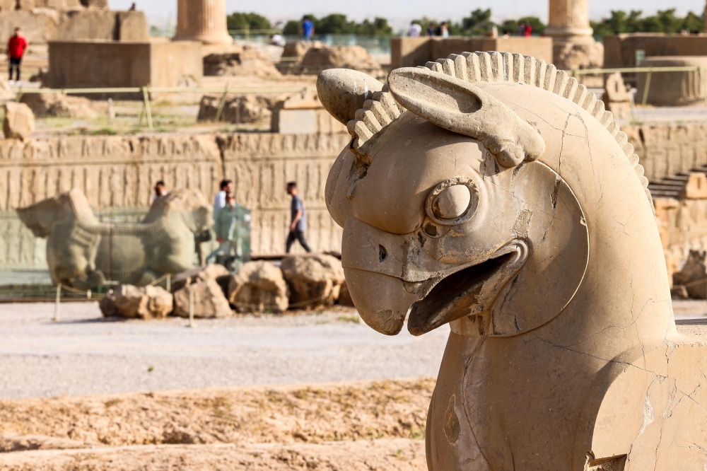 This picture taken on May 13, 2024 shows a view of a sculpture of the mythical "Huma" double griffin in the ruins of ancient Persepolis