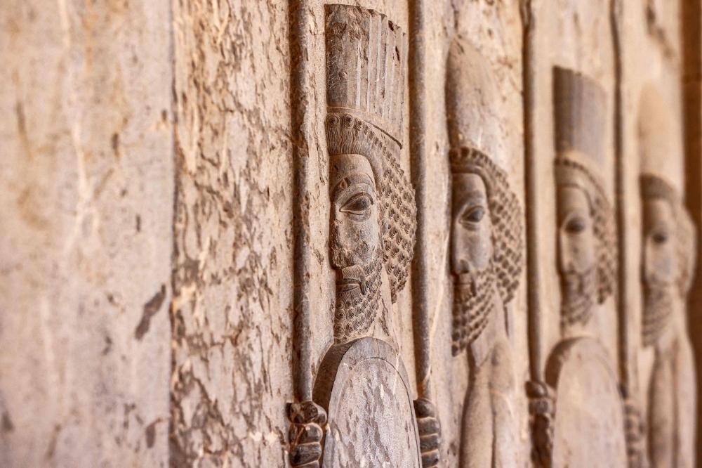 Reliefs depicting ancient warriors are pictured on a wall at the ruins of ancient Persepolis
